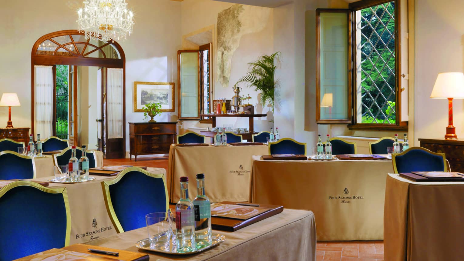 Giusti Meeting Room with rows of small tables, blue and gold chairs 