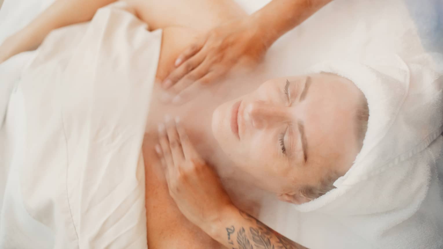 A woman receiving a facial massage in a spa.
