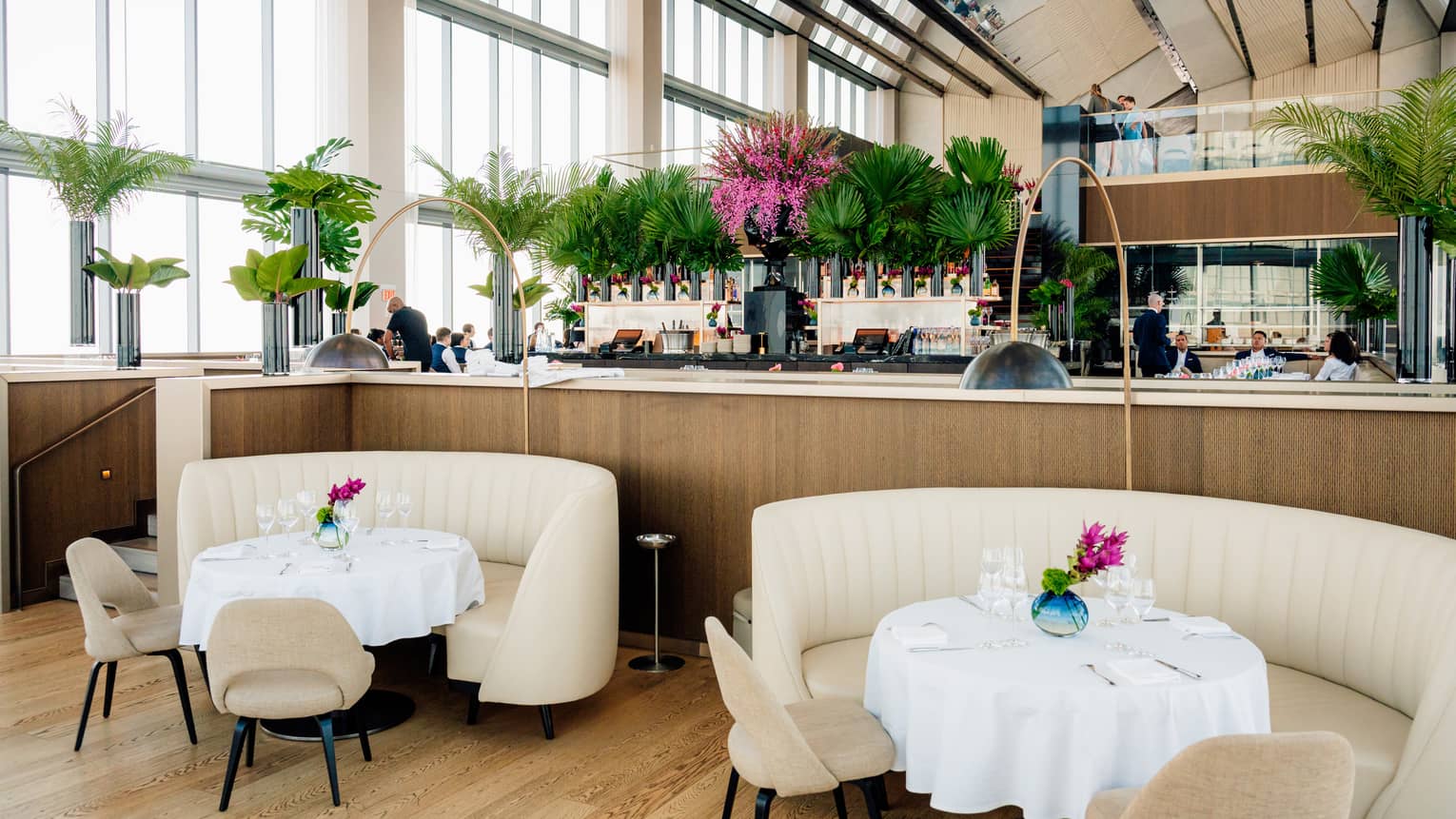 Dining tables in restaurant atrium with high ceilings