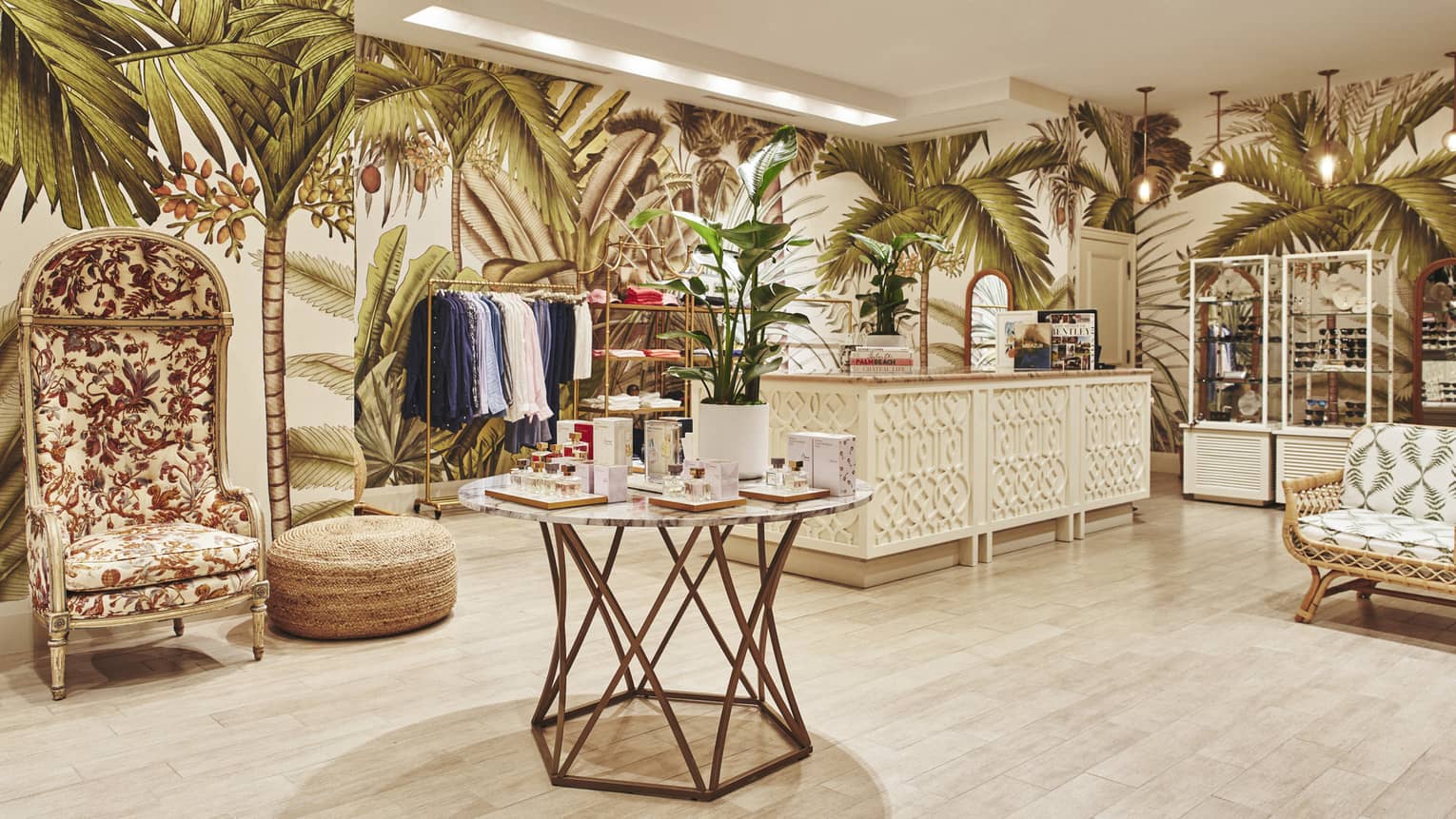 A brightly lit store with light wood features and clothes on shelves and hangers.