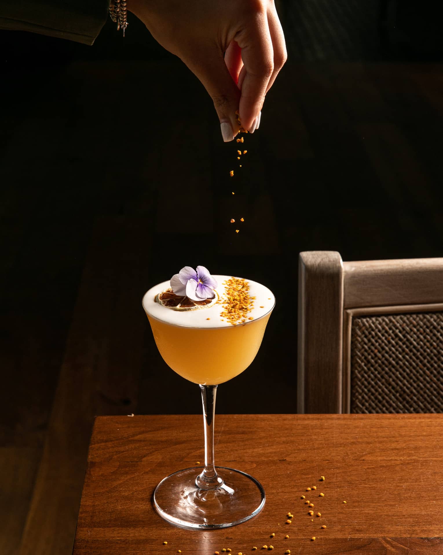 A cocktail being garnished.