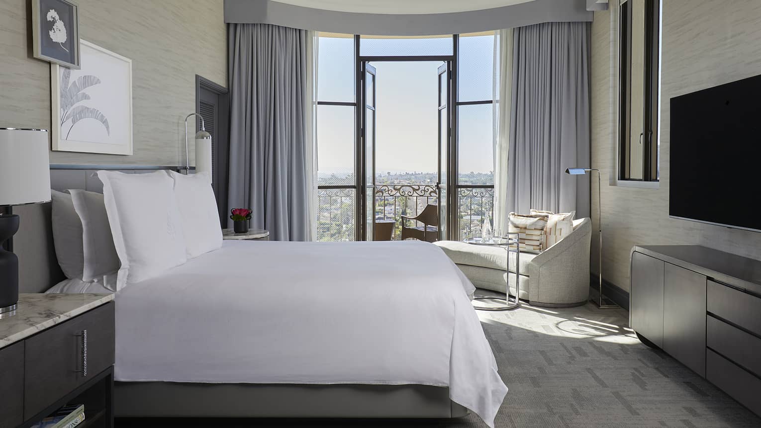 Bedroom with king bed and city-view balcony