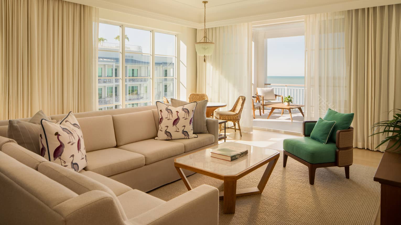 Luxury resort suite featuring a living room with white sectional sofa