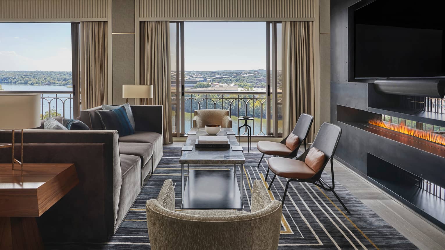 Presidential Suite large seating area by windows, modern fireplace under TV