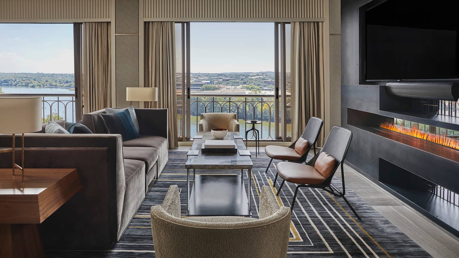 Presidential Suite large seating area by windows, modern fireplace under TV