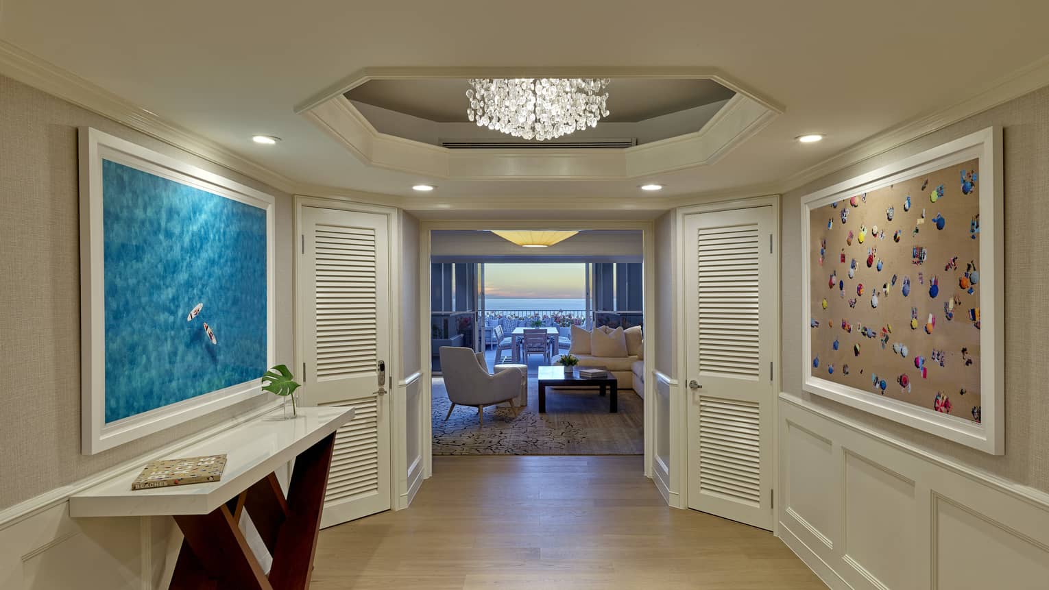 Hallway with chandelier, sideboard, artwork