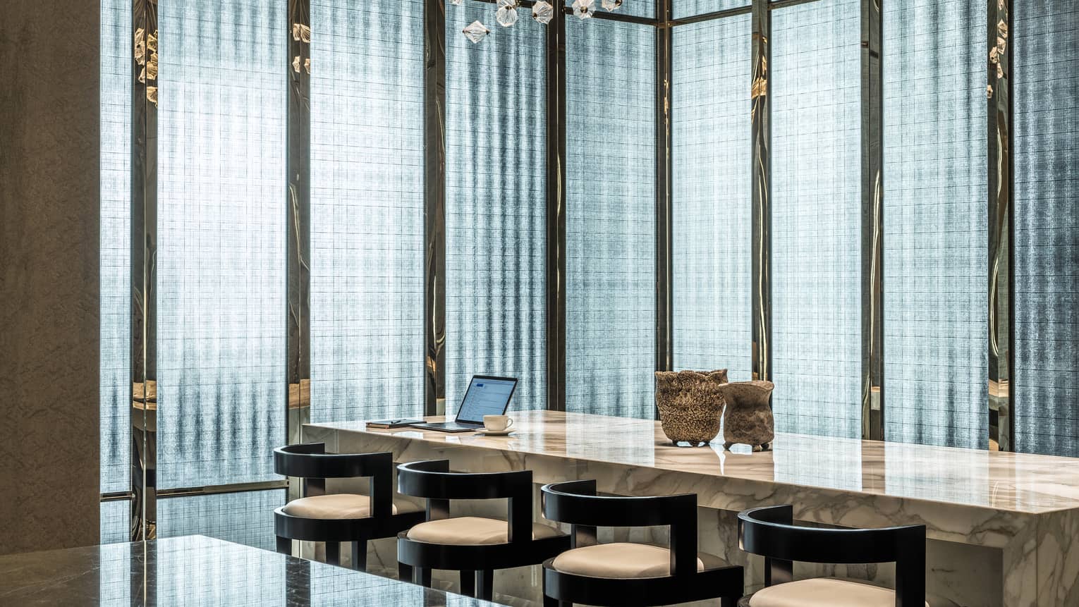 Library with marbled worktop and four bar stools