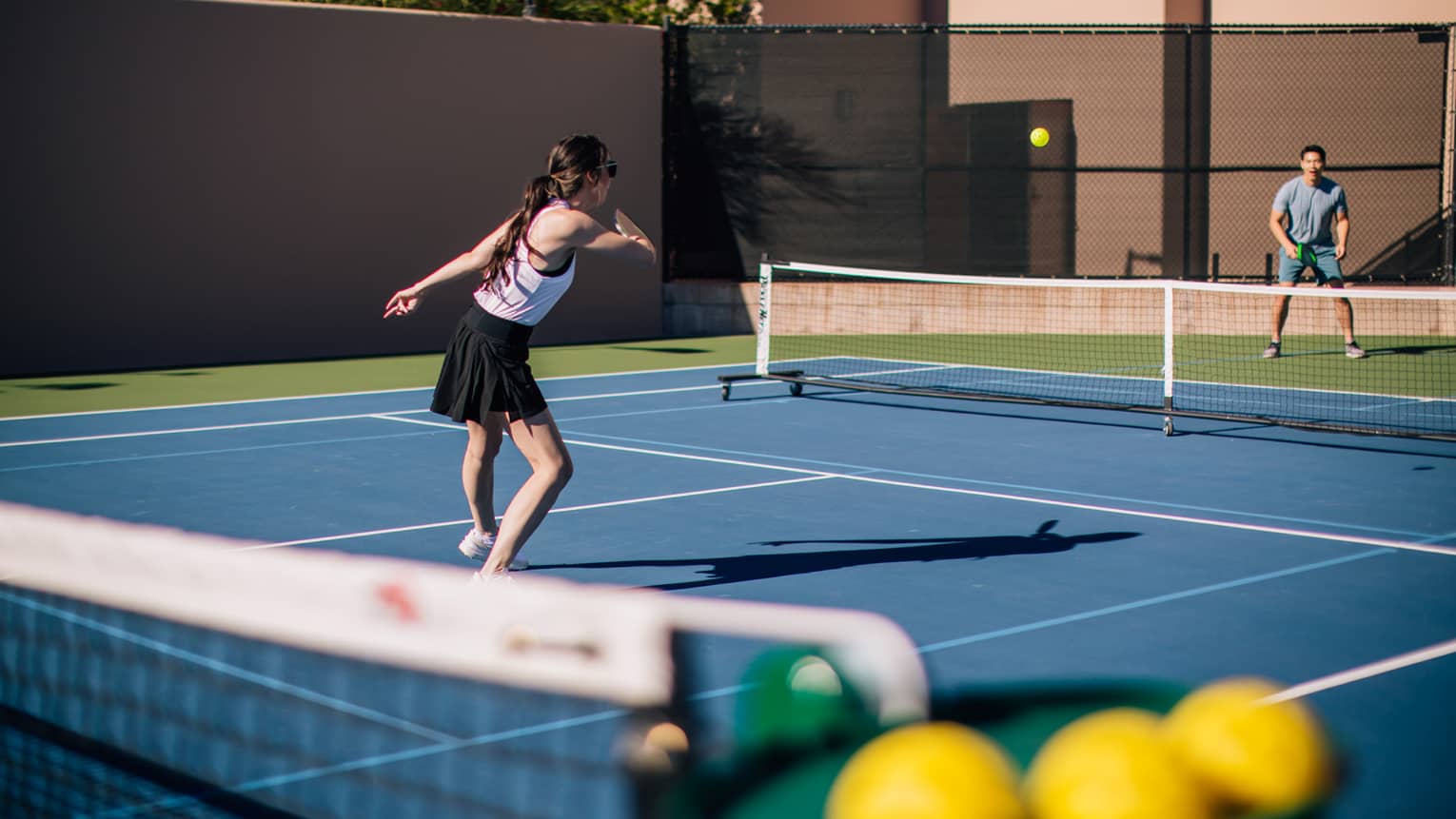 A woman and man on a tennis court.
