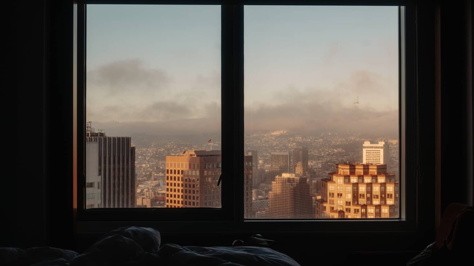 Window from hotel room looks out to city view in San Francisco