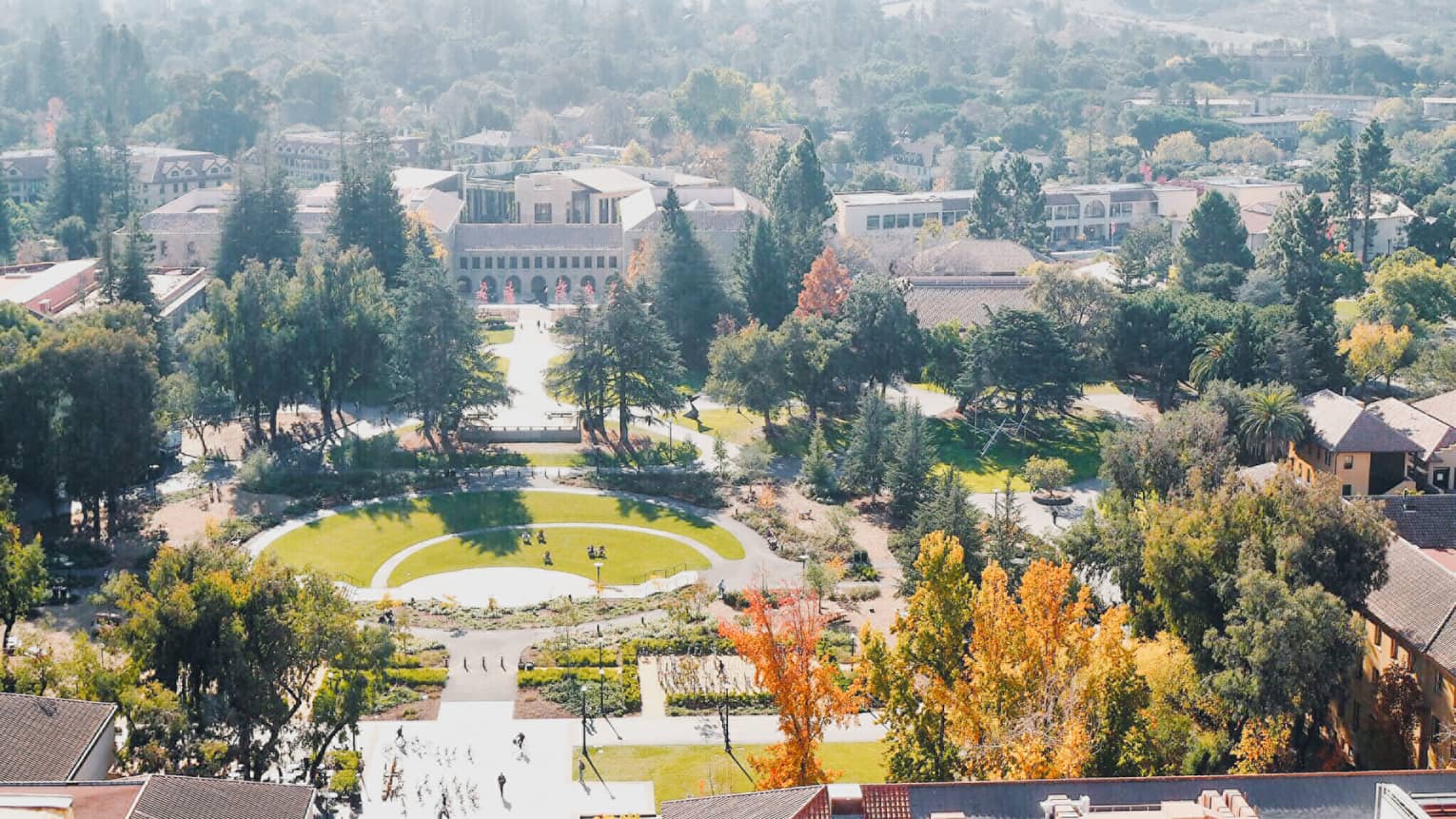 Aerial view over Stanford University campus grounds, buildings on sunny day