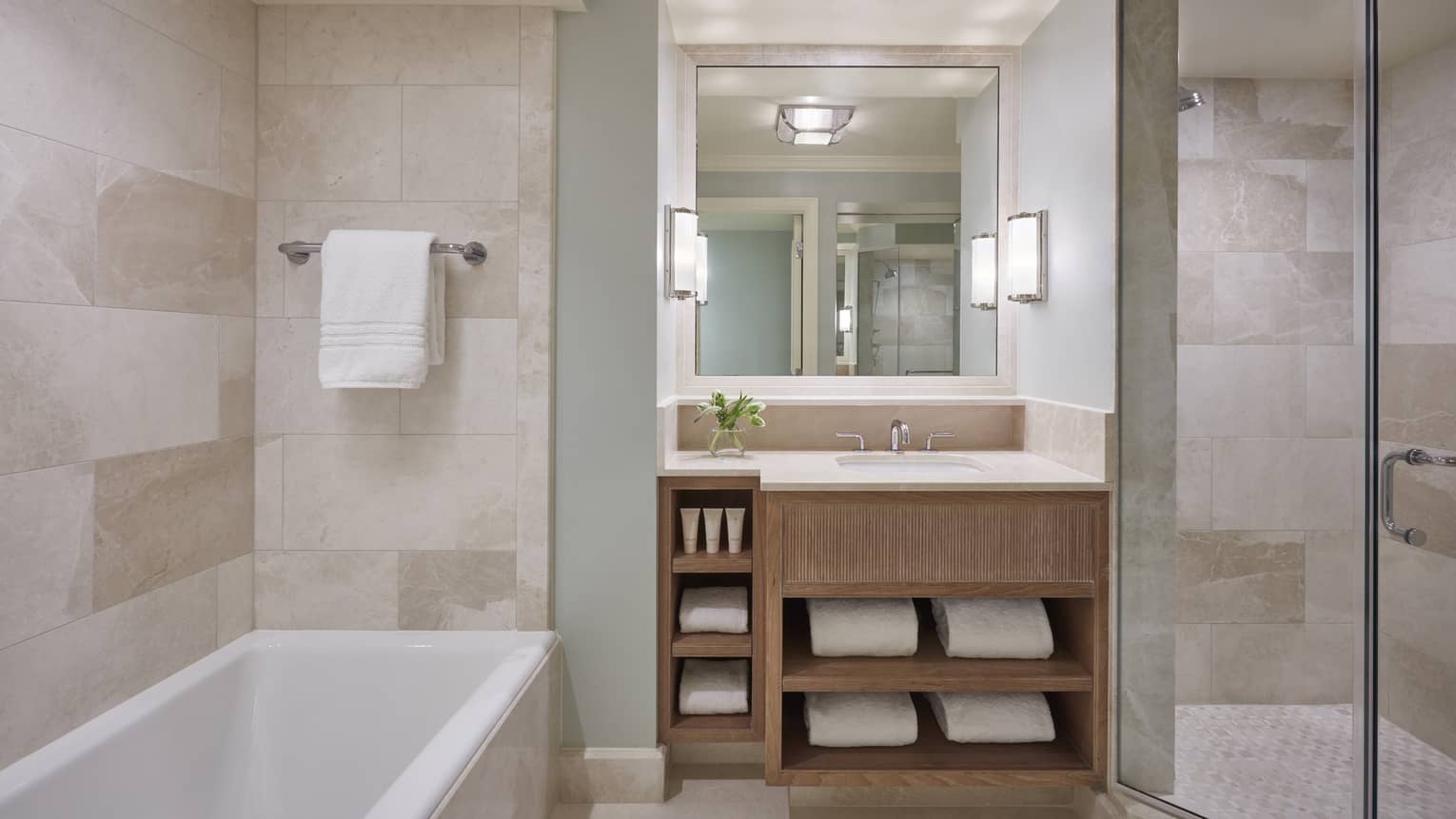 Modern hotel bathroom with a tub and marble walls