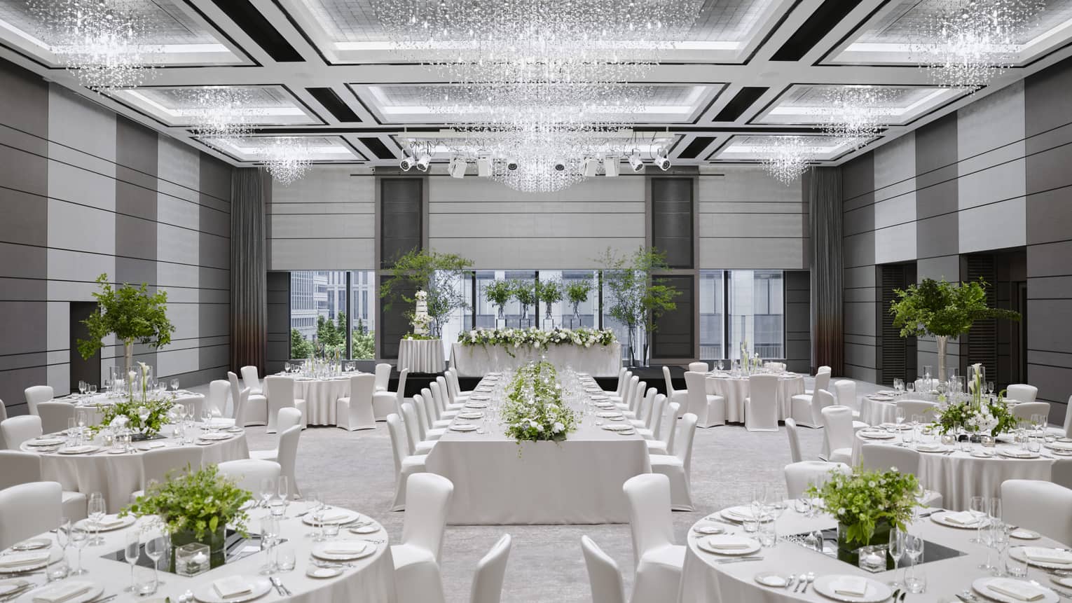 Wedding reception, round tables and chairs with white linens in ballroom 