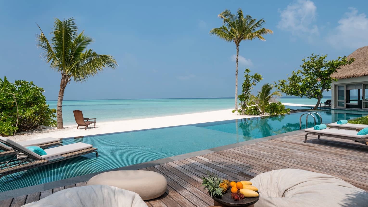 Three-Bedroom Beach Villa fresh fruit on platter on deck by swimming pool, beach