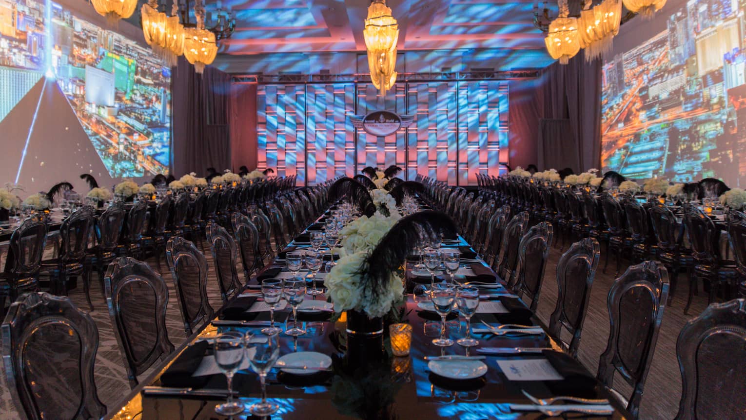 Dining room with neon lights, projections on walls, modern tables and chairs under hanging lamps