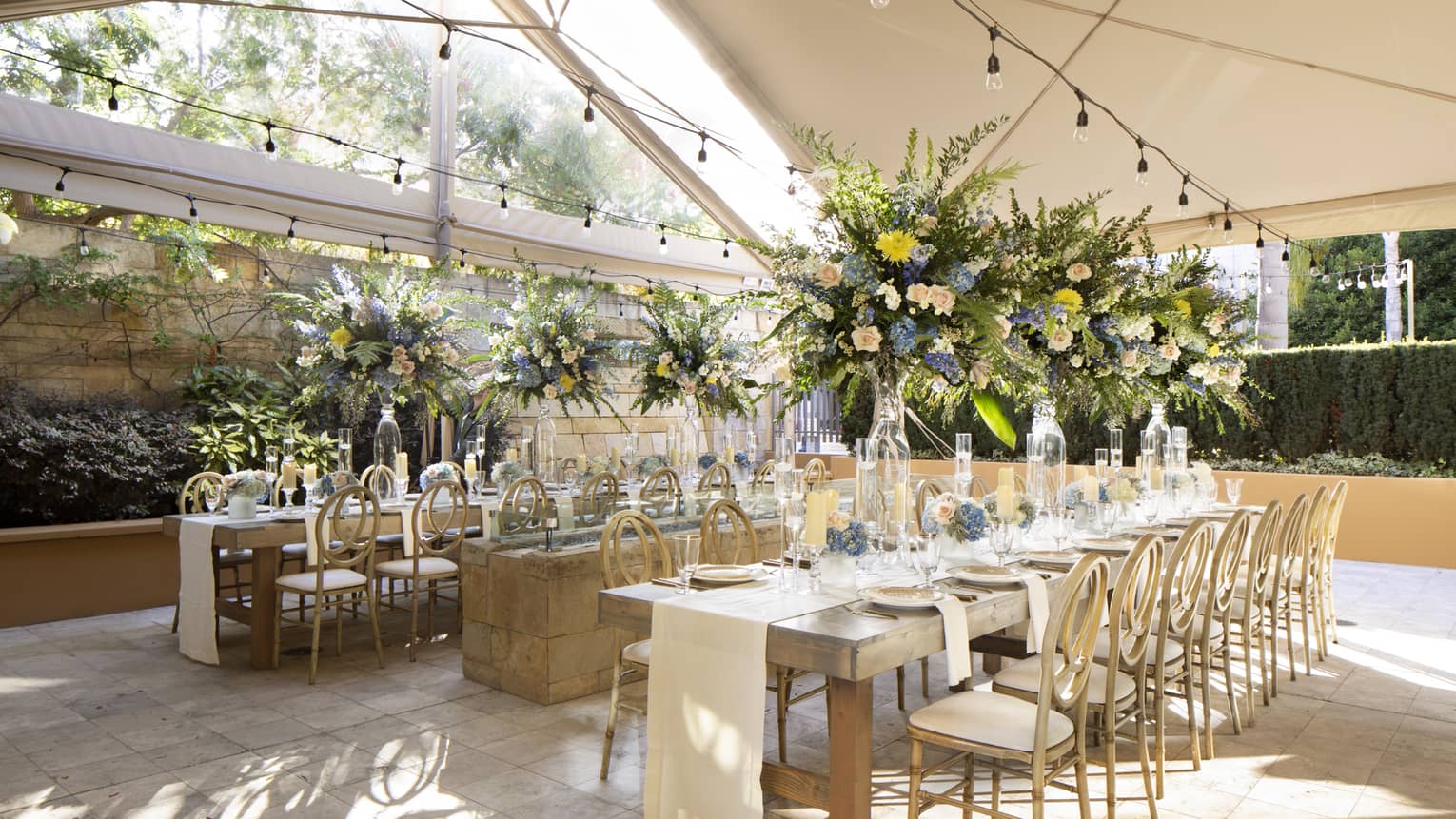 Covered outdoor terrace with tables set for dinner