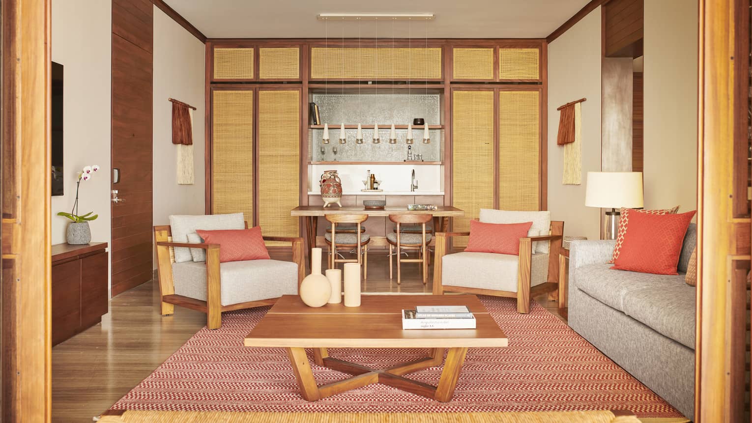Resort suite living room with two chairs, sofa and dining table