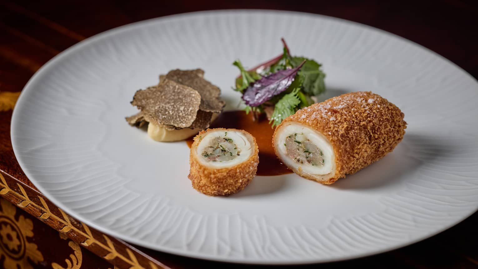 A turbot croquette served on a white plate