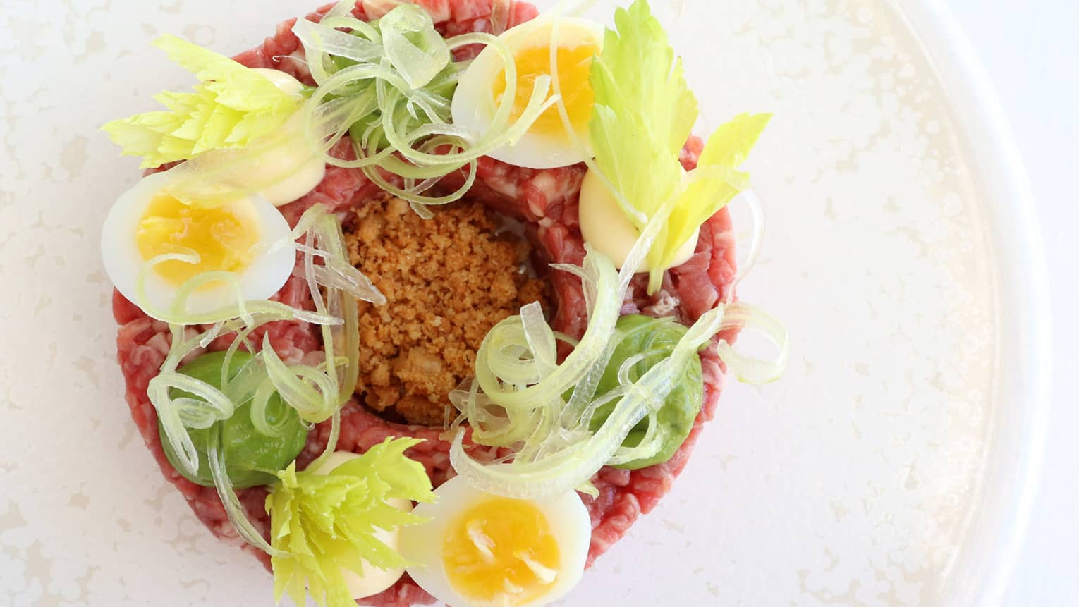 Fassona Tartare with Fassona Beef Tenderloin, Landaa Quail Egg, Royale, Salsa Verde and Anchovy Crumble