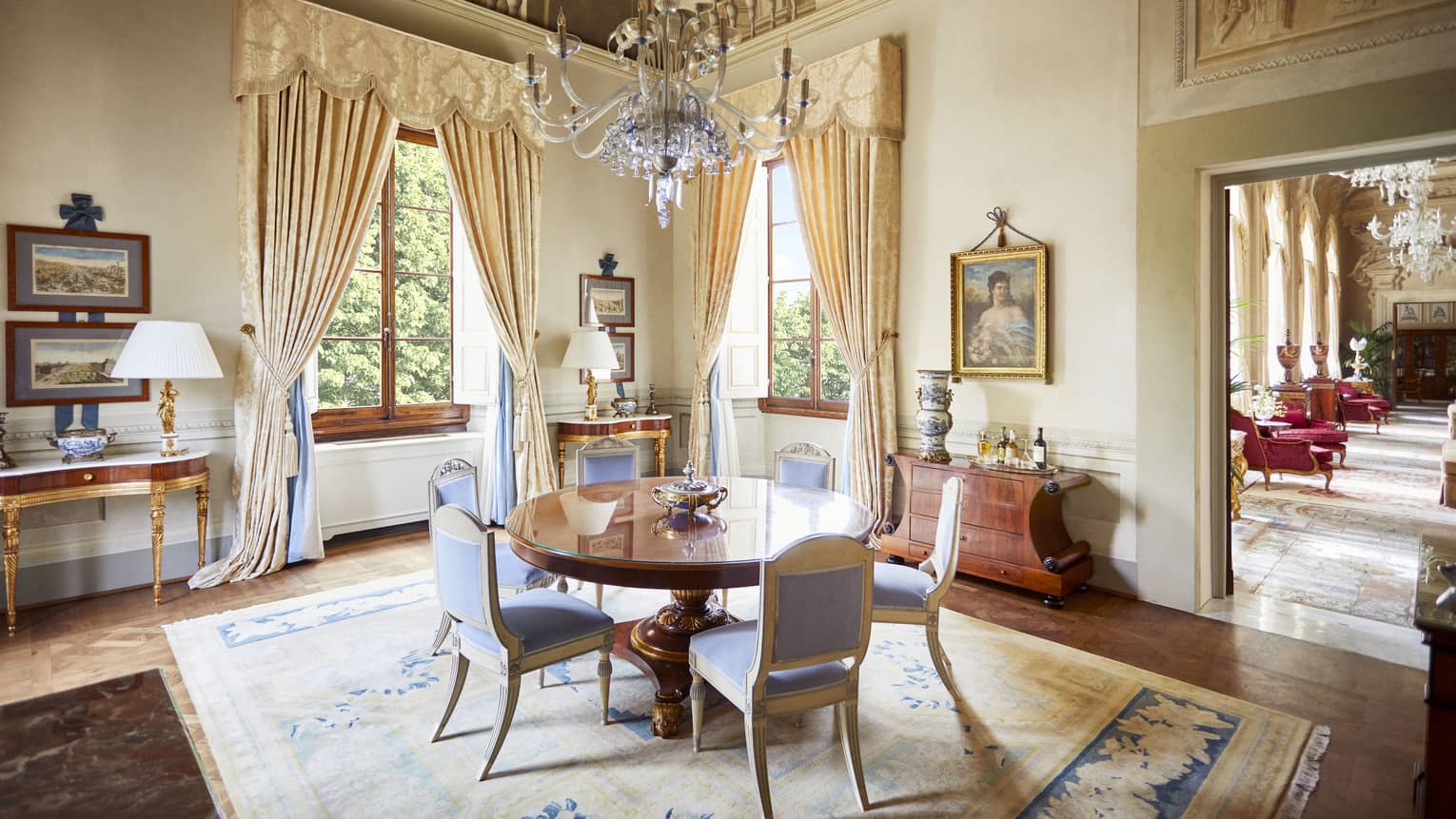 Royal Suite dining room with round table six upholstered chairs, frescoed ceiling with chandelier, at Four Seasons Hotel Florence