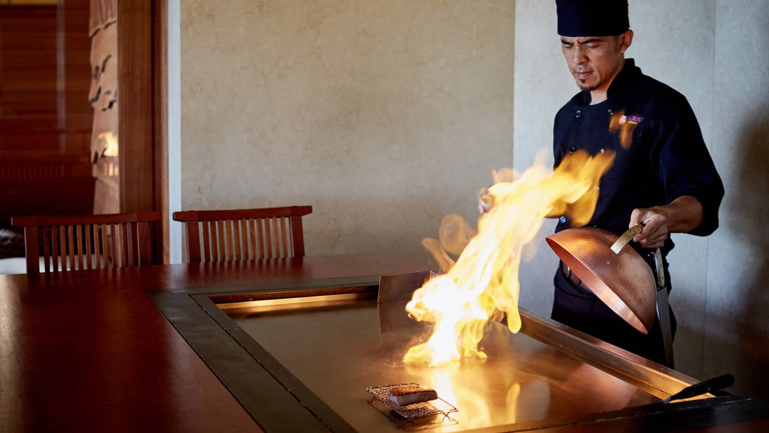 Flames shoot up from grill as NOBU restaurant chef pulls back copper lid