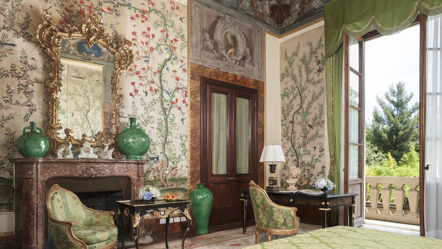Hotel room with elaborate floral wall paper and fresco ceiling
