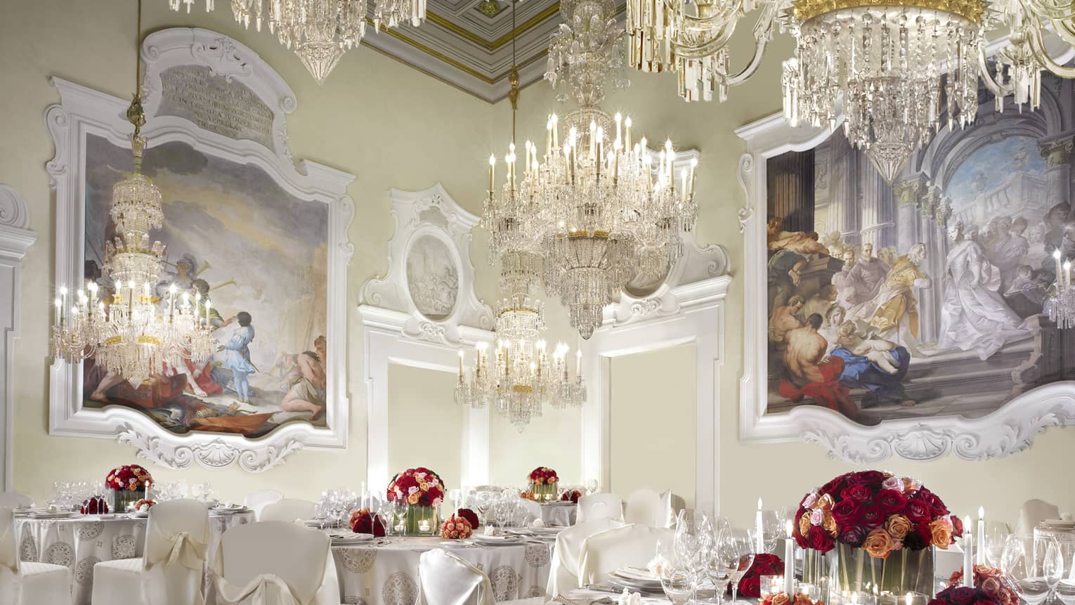 Gherardesca ballroom with large crystal chandeliers, paintings over elegant banquet tables 