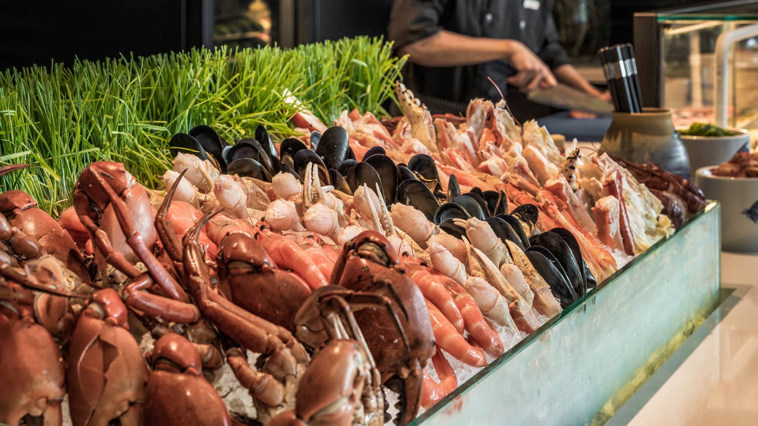 Curate seafood station with chef laying out food