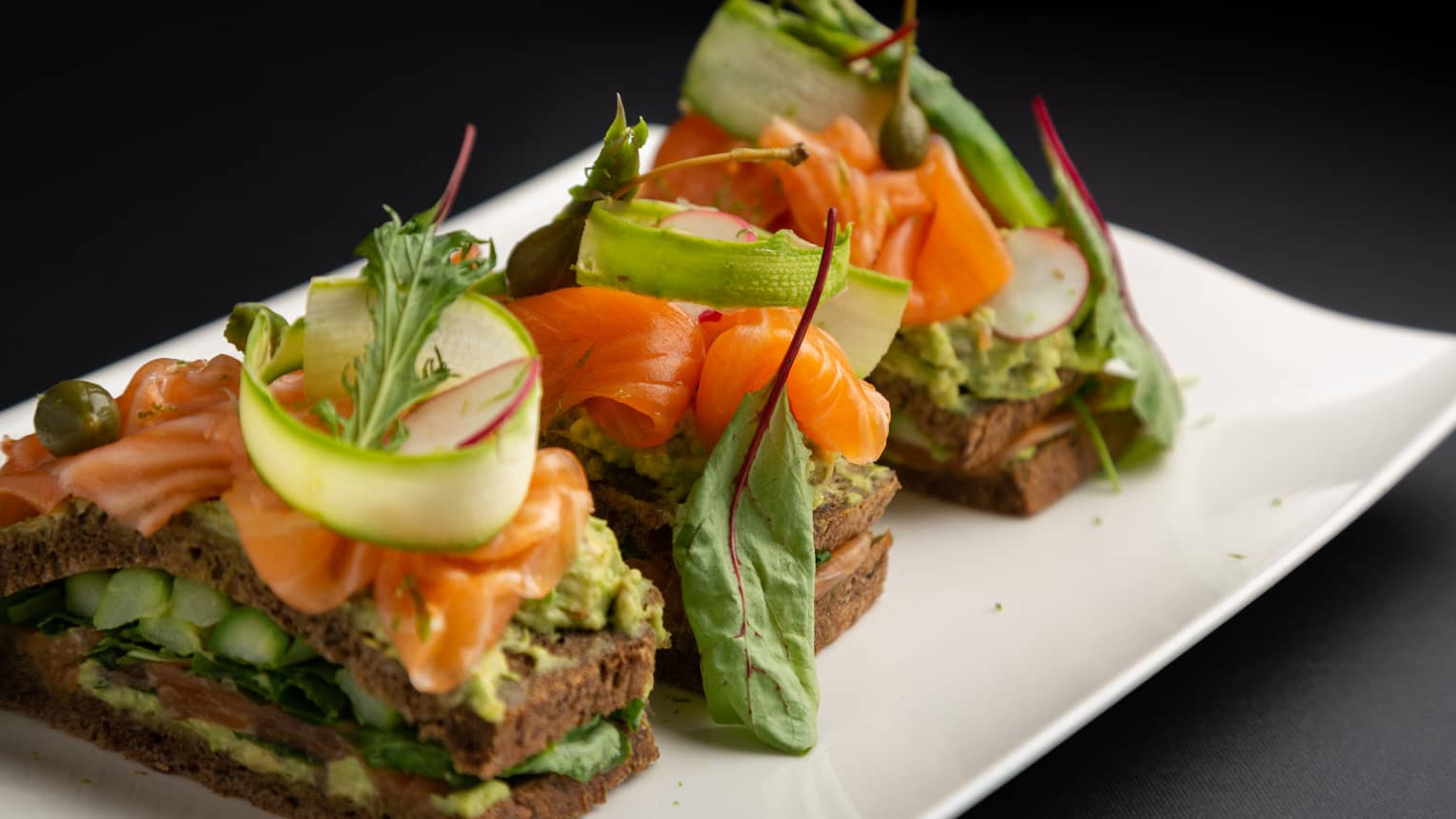 Scottish smoked salmon club sandwich with avocado, sucrine lettuce and radish