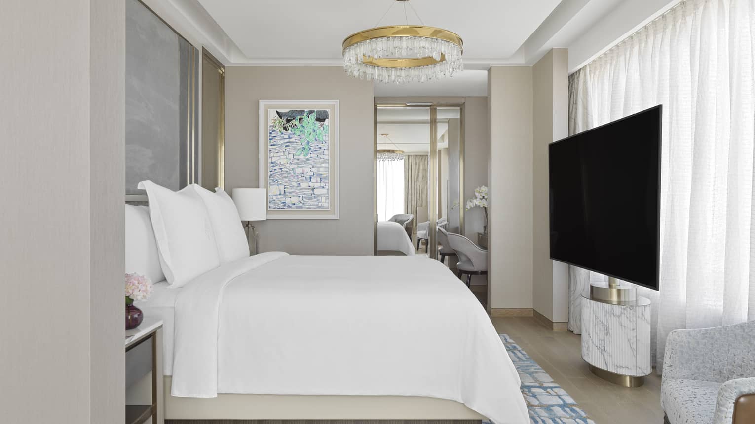 Bedroom with gold and crystal chandelier and a TV at The Grand Suites at Four Seasons, Macao