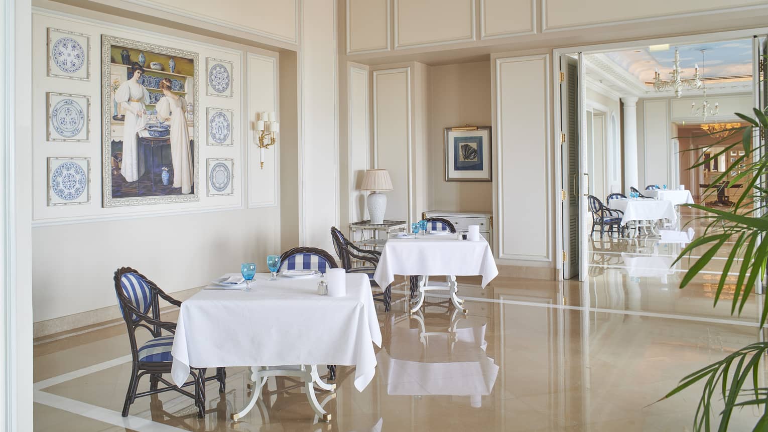 Interior of Kala Restaurant with square tables, white linens, natural light