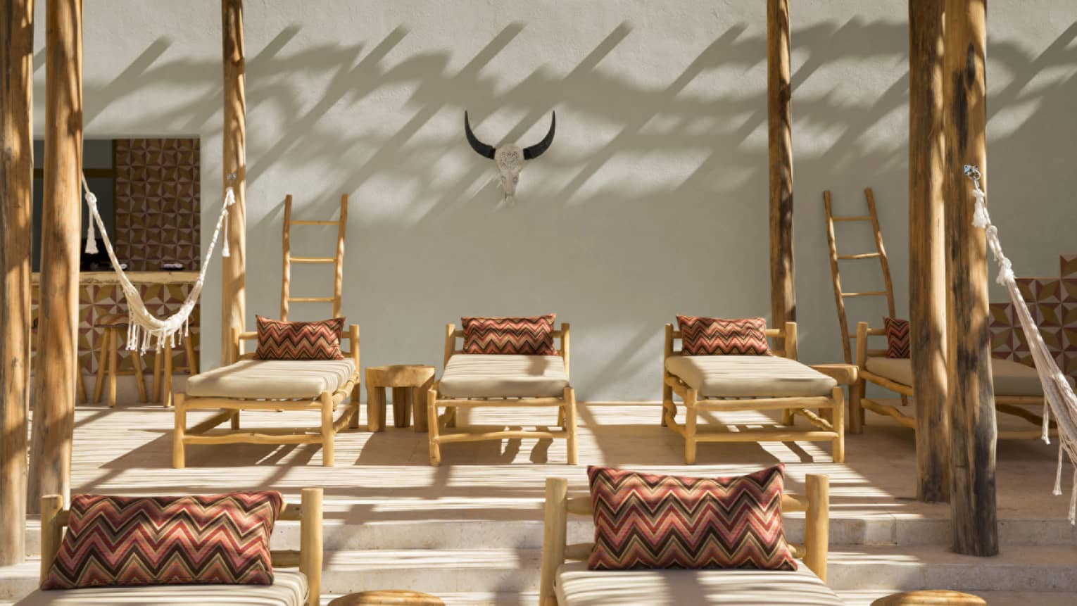Bamboo lounge chairs with Mexican-inspired pillows on terrace