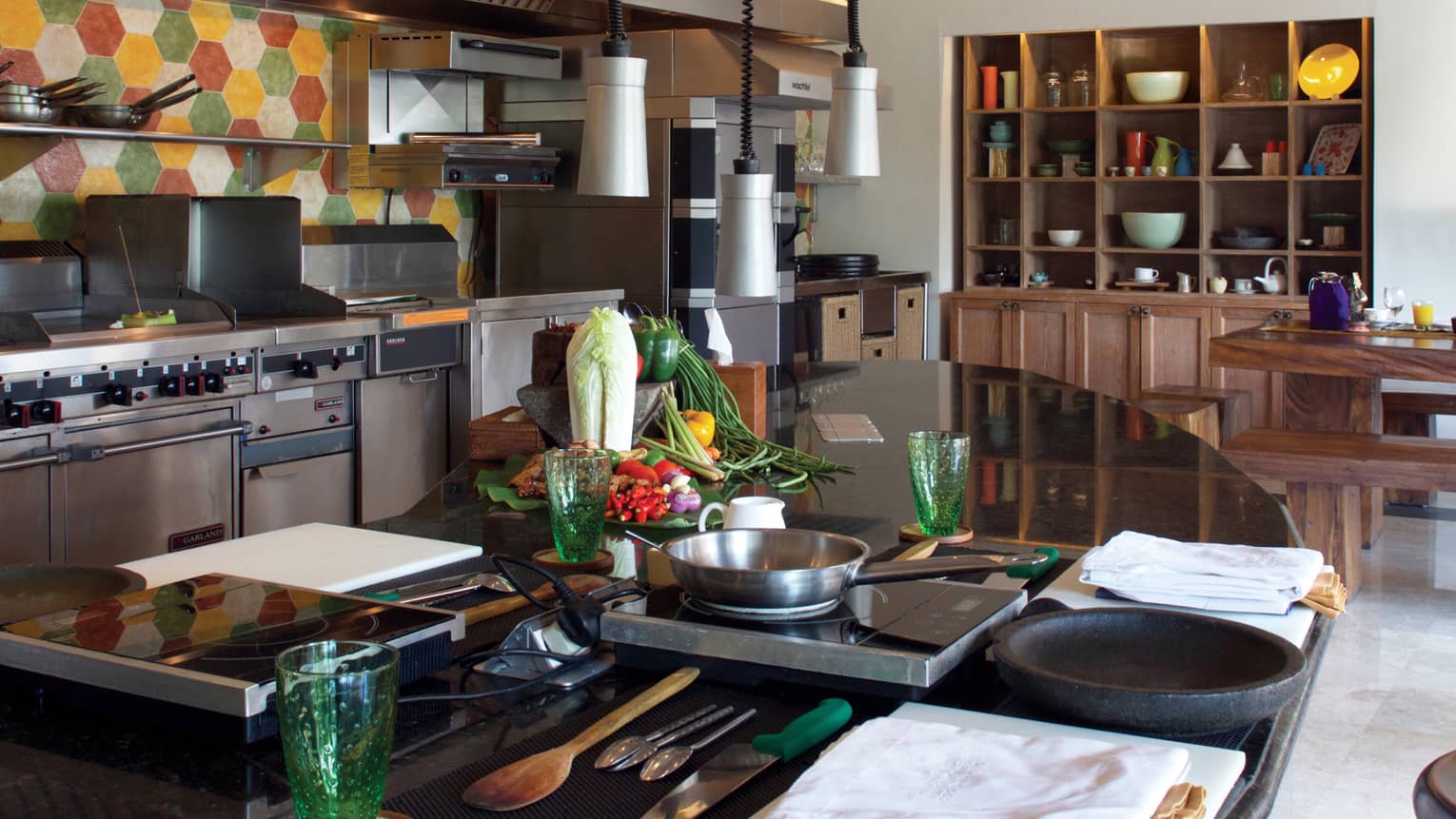 Jala Cooking Academy class station, table with hot plates, pans near stoves