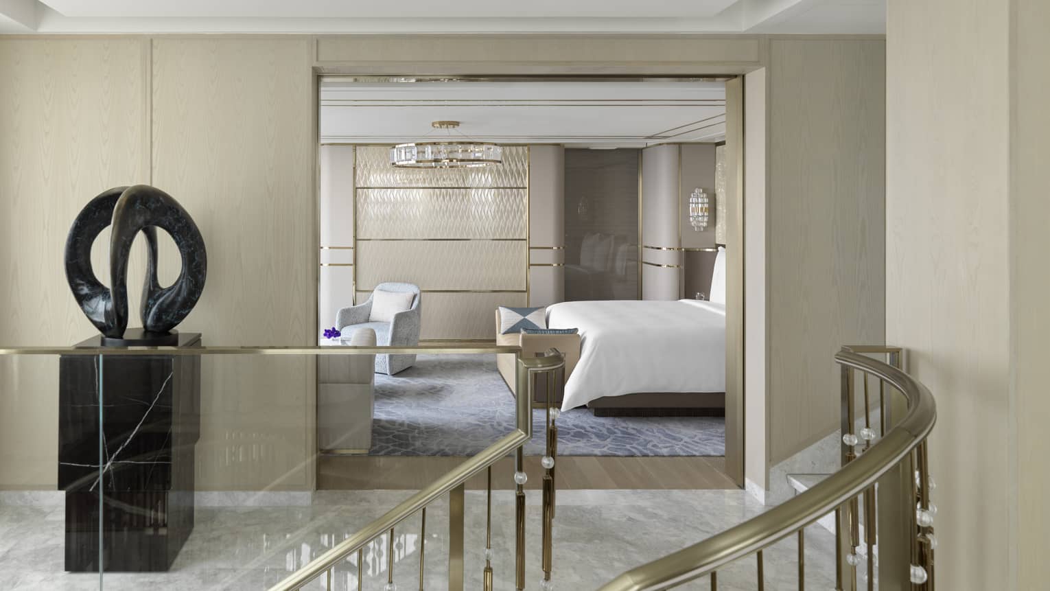 A grand staircase leads to an upstairs hallway with art sculpture, and a bedroom, The Grand Suites at Four Seasons, Macao