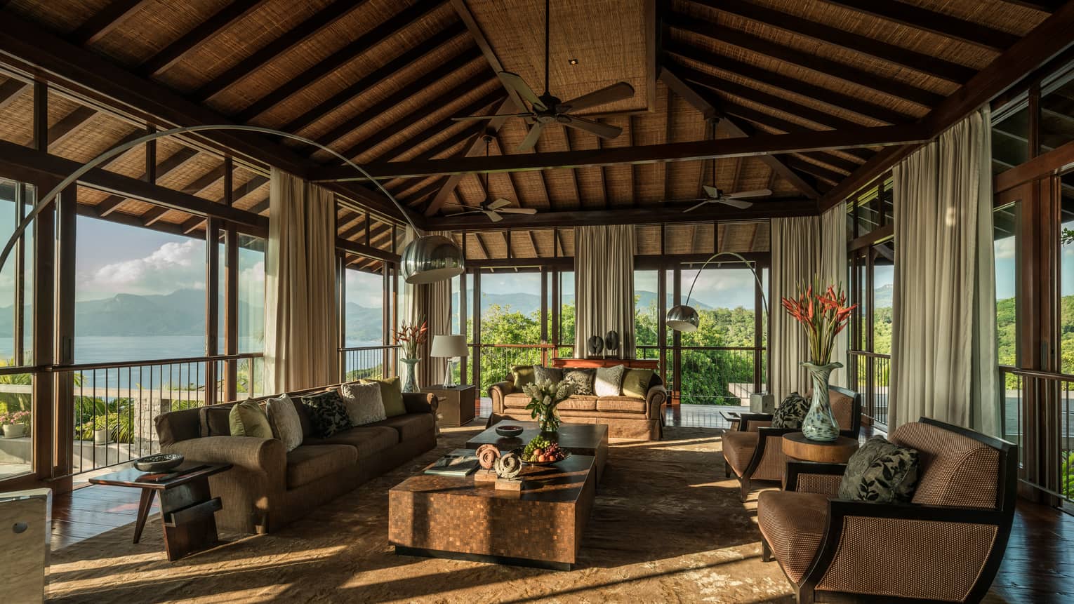 Five-Bedroom Residence Villa open-air living room sofas, armchairs, tables under wood-beam roof