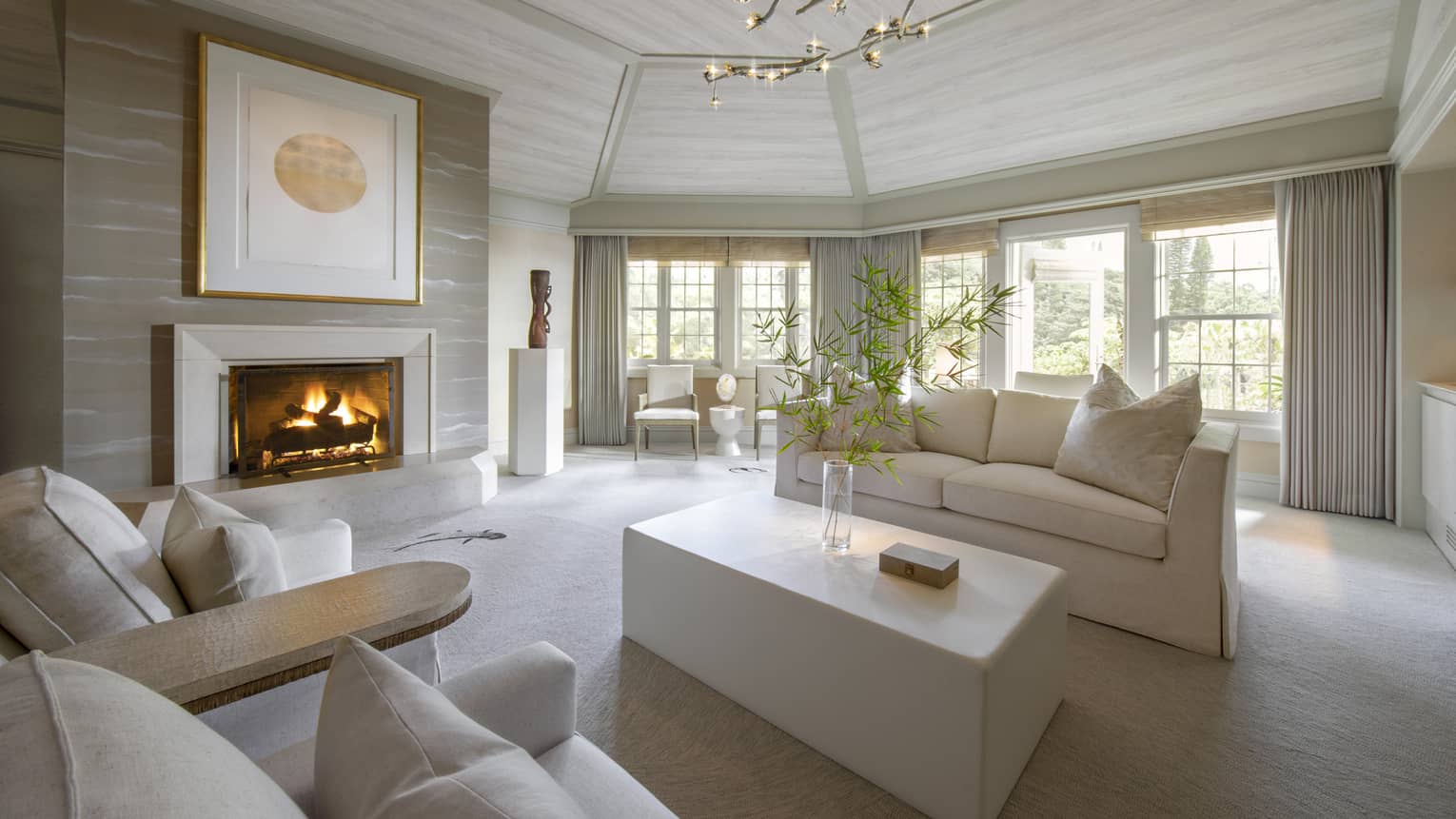 Guest suite living room with white couch and fireplace