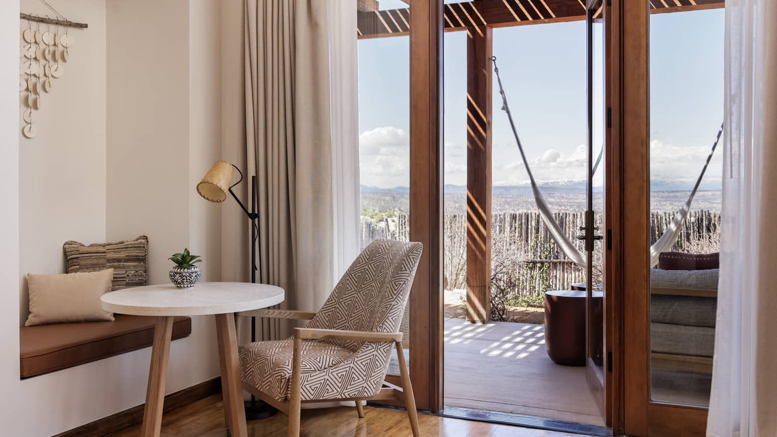 Sitting area and walk-out terrace of hotel suite at Four Seasons Resort Santa Fe