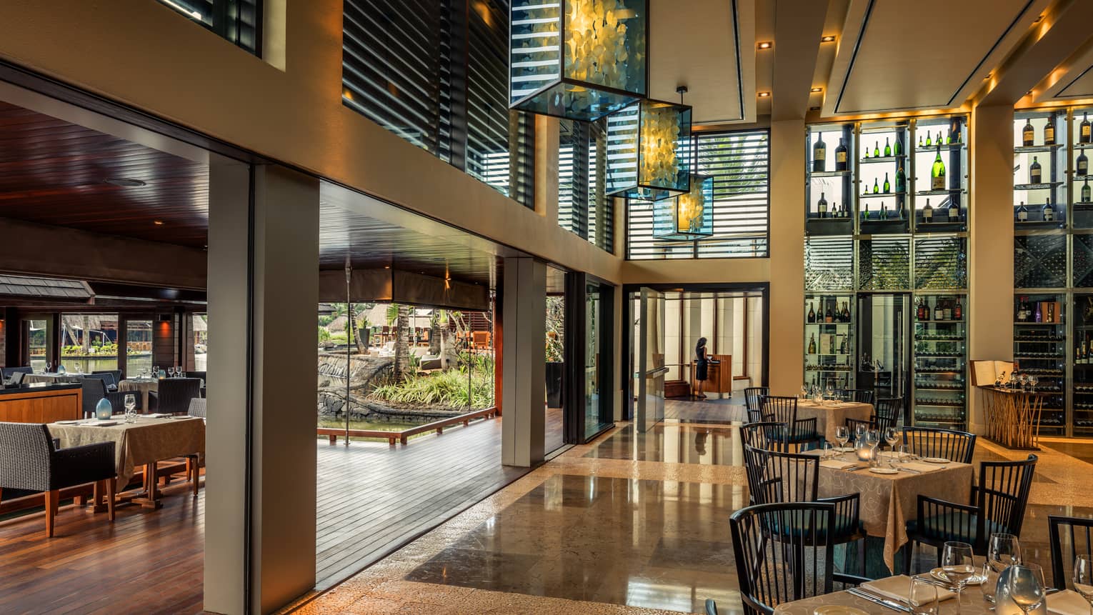 Beau Champ dining room with modern beams, glass lantern chandeliers 