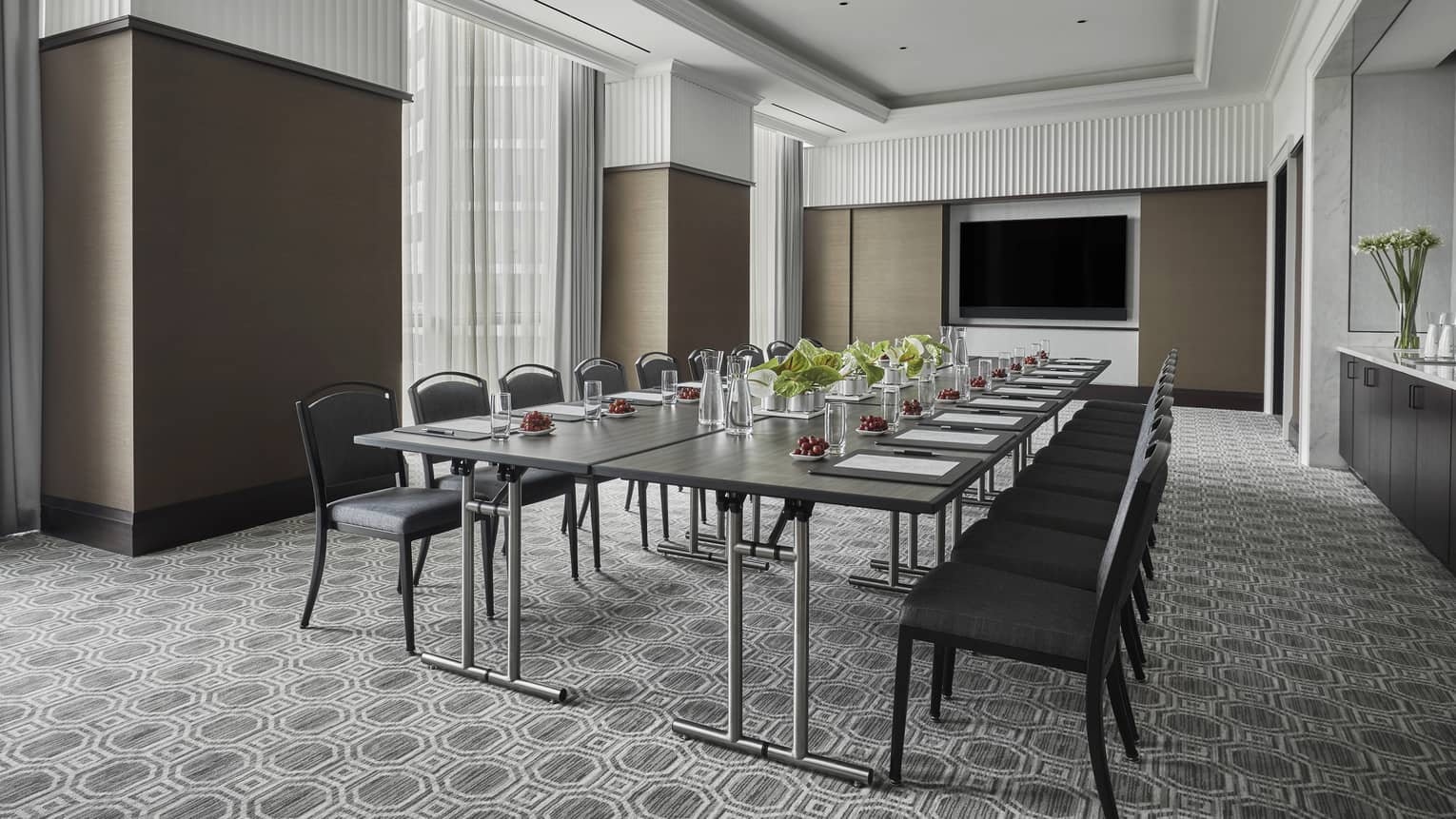 Fairfield Room, empty but ready for a meeting with one long rectangular table set with pens and paper