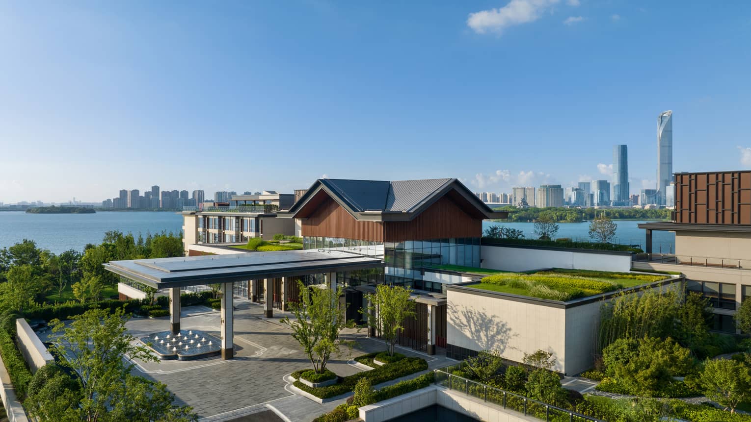 Exterior of Four Seasons Hotel Suzhou, with lake and city in background