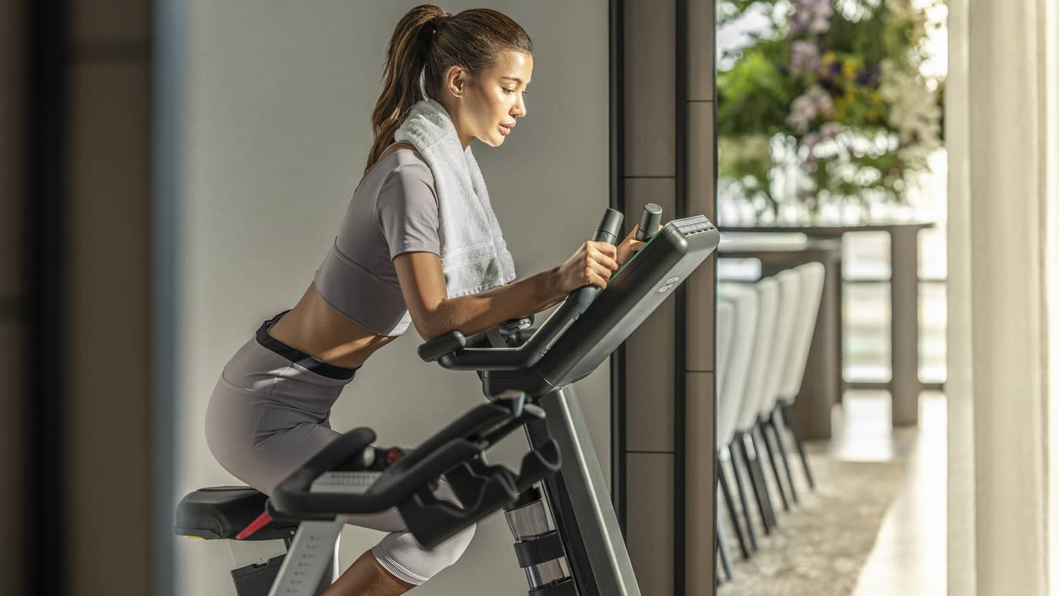 Woman rides Peloton in Presidential Suite
