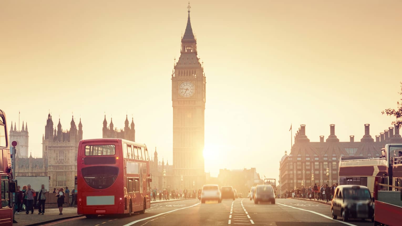 Street view of London at sunset, Big Ben tower and red double-decker bus in background