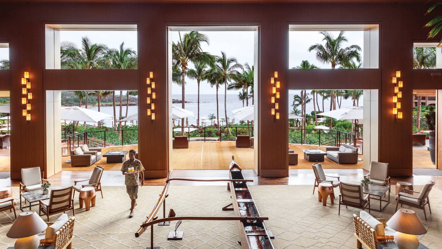 Restaurants In Lanai Lounges Bars Four Seasons Resort Server Carries Tray With Tails Through Large Malibu Farm Bar Dining Room
