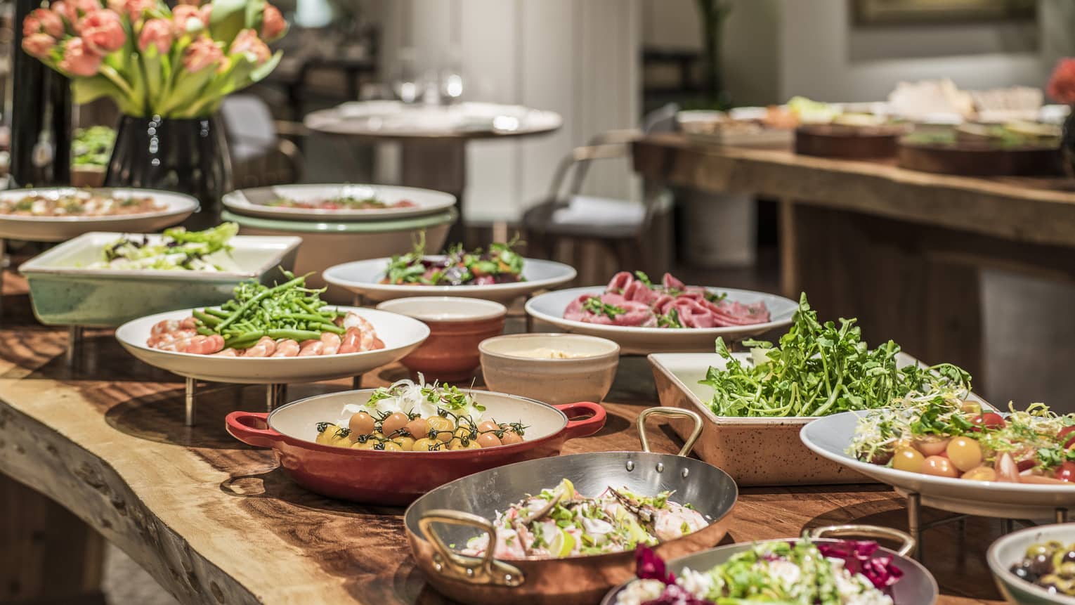 A lunch buffet arranged with platters of seafood, fresh vegetables and a large variety of other options at the One Ninety Restaurant