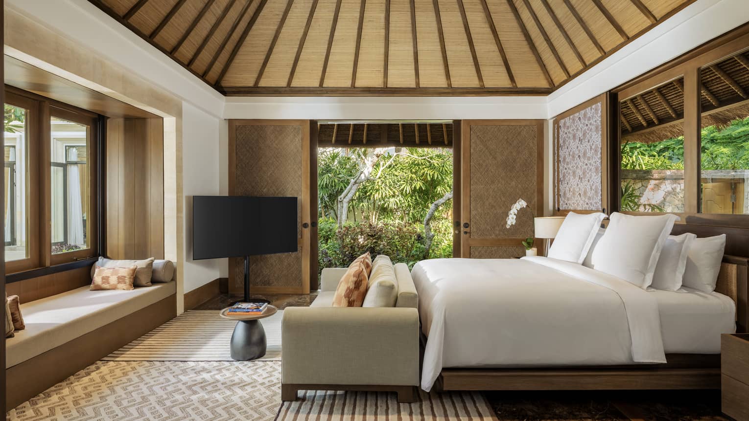 Luxury bedroom with king bed, garden views and vaulted ceiling in private residence at at Four Seasons Resort Bali at Jimbaran Bay