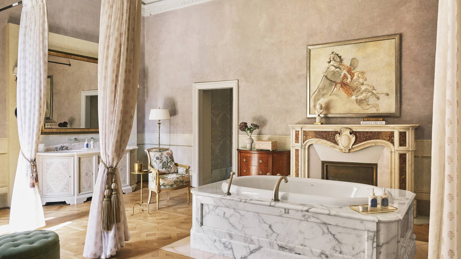 Renaissance Suite bathroom with marble tub set in the middle of the room next to a grand fireplace, at Four Seasons Hotel Florence