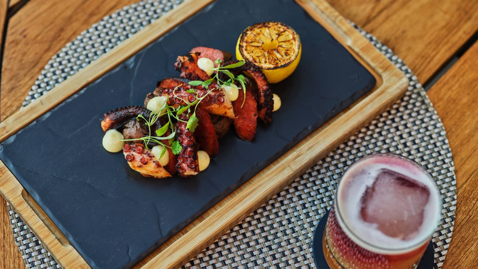 Grilled octopus dish with cocktail