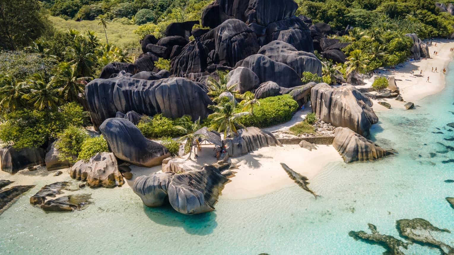 Rocky island white-sand beach with clear turquoise water