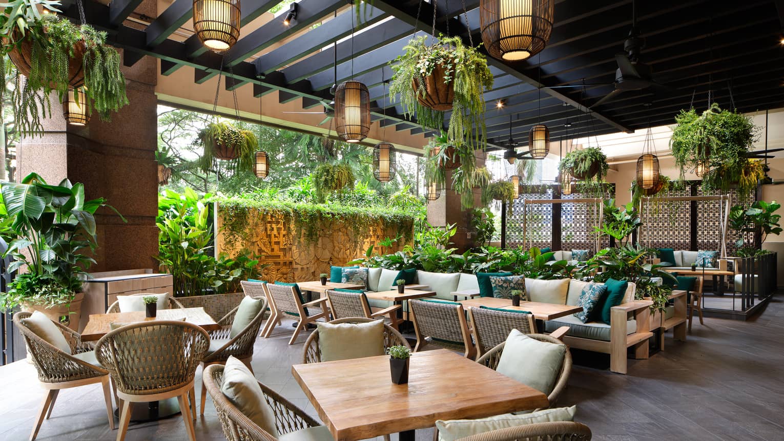 Garden@One-Ninety outdoor lounge with rattan chairs, square tables for four, portico ceiling, hanging plants and lighting