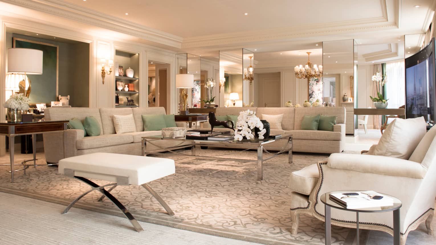 Royal Suite large living room, white sofas, armchairs, lamps, mirror walls