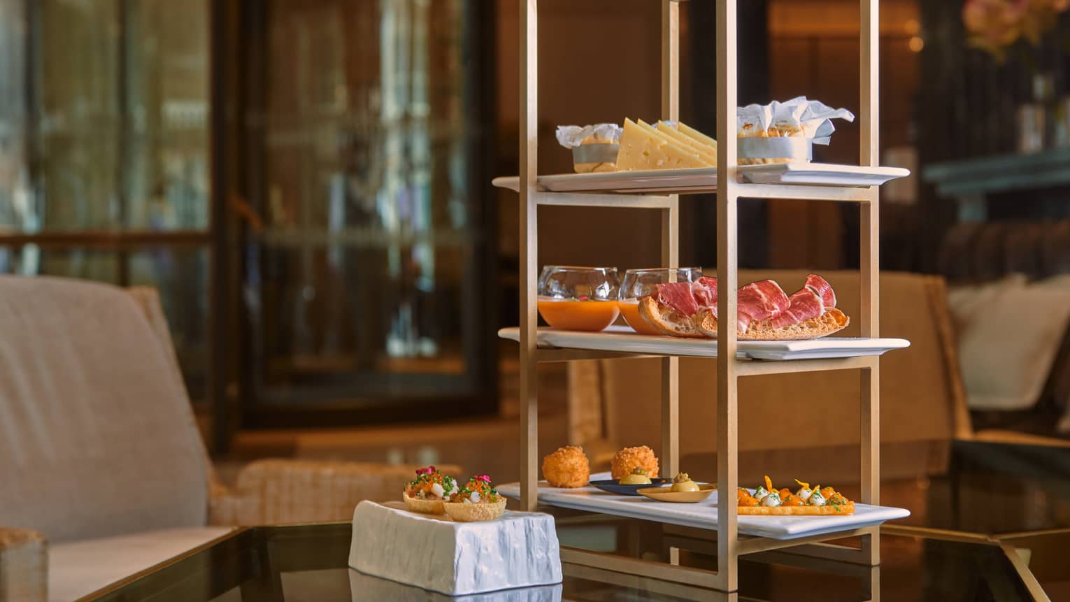 Tapas on a three-tiered stand atop dining table